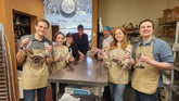 Happy participants showing off handmade chocolate truffles during a hands-on truffle-making class at The Secret Chocolatier in Charlotte, NC.